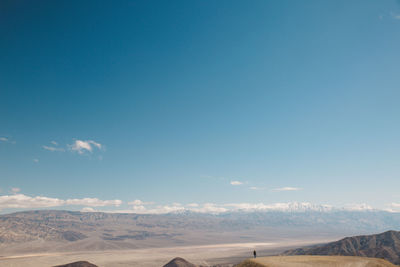 Scenic view of desert against blue sky