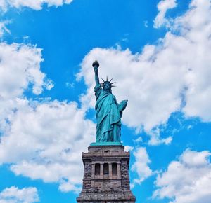 Low angle view of statue against cloudy sky