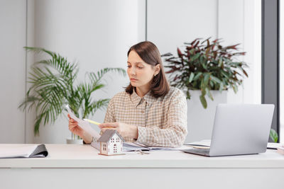 Young woman using laptop at home