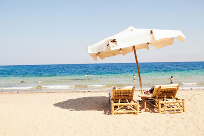 Relax on the beach near the sea, the ocean. with umbrella and two chairs