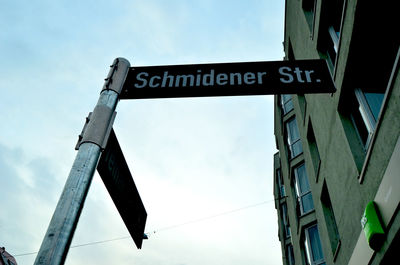 Low angle view of road sign against sky