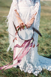 Rear view of woman standing on field