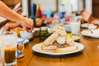 Fresh homemade variety bread on a white at breakfast table.