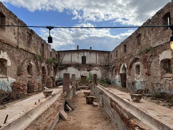 Low angle view of old ruins against sky