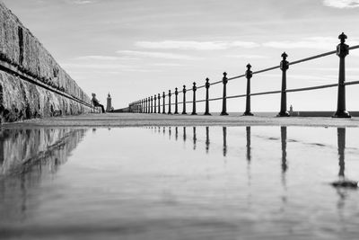 People walking on pier against sky