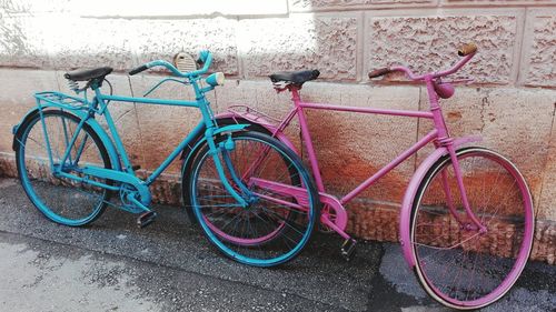 Bicycles parked against wall