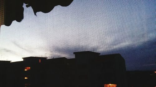 Low angle view of illuminated building against sky