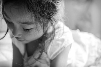 Close-up of cute girl looking down