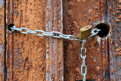 Detail of portuguese wooden peeling off door with metal lock