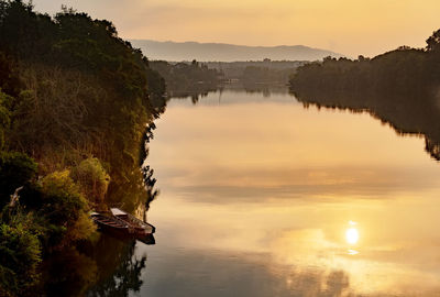 Scenic view of lake against sky during sunset