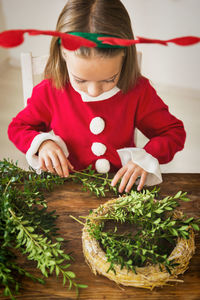 Close-up of girl playing with christmas tree