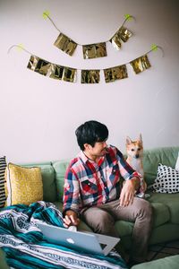 Man sitting on sofa at home