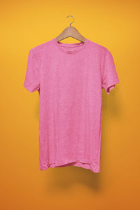 Close-up of pink umbrella against yellow background