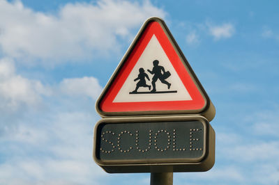 Swiss italian warning school street sign with italian scuole inscription against a blue sky 