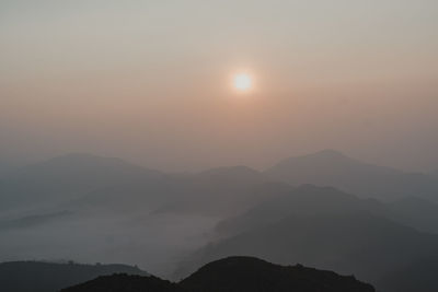 Scenic view of silhouette mountains against sky during sunset