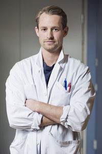 Portrait of confident male doctor with arms crossed in hospital