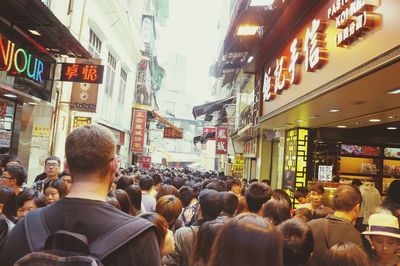 Rear view of people at street market in city