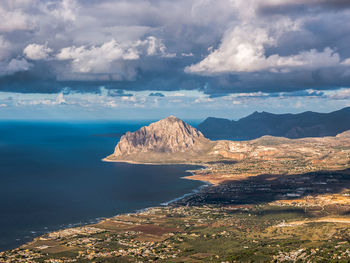 Scenic view of sea and mountains against sky