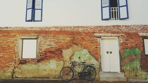 Bicycle against wall of building