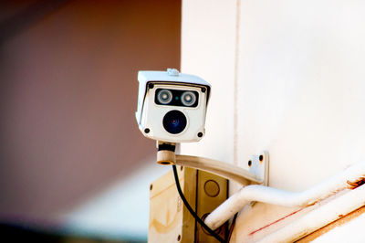 Close-up of camera on wall at home