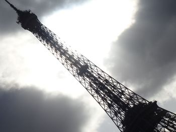 Low angle view of crane against cloudy sky