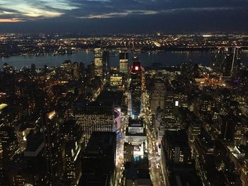 Aerial view of city lit up at night