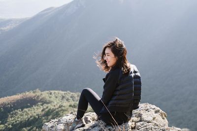 Full length of woman standing on mountain