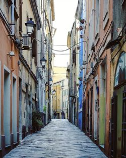 Narrow street amidst buildings in city