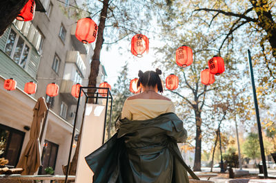 Portrait of young woman standing in city