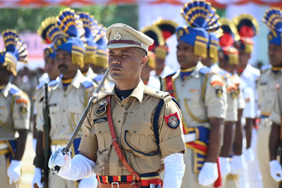 Rear view of soldiers standing in city