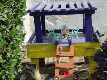 High angle view of birdhouse on bench against plants