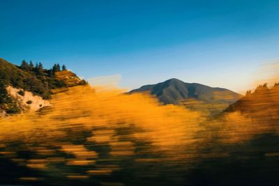 Scenic view of mountains against clear blue sky