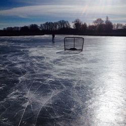 Scenic view of frozen lake against sky during sunset