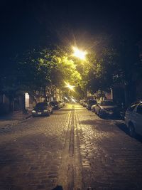 Cars parked on road at night