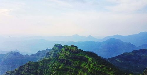 Scenic view of mountains against cloudy sky