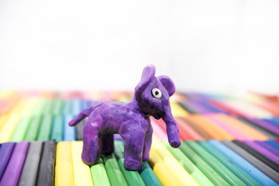 Close-up of multi colored stuffed toy on wood