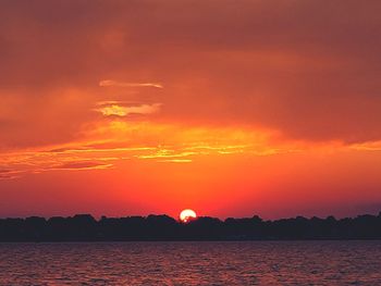 Scenic view of sea against romantic sky at sunset