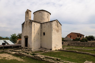 Old building on field against sky