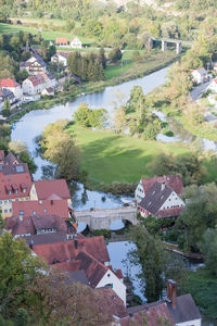 High angle view of townscape by river against buildings