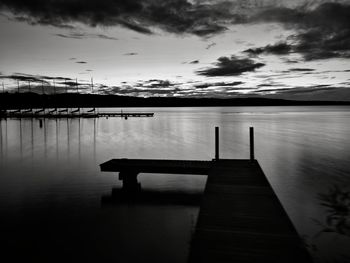 Pier over lake against sky