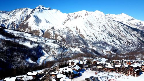 Scenic view of snow covered mountains against sky