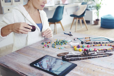 Midsection of woman working at table