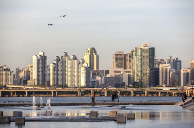 People in park with skyscrapers in background