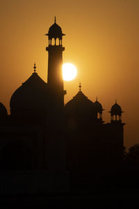 Taj mahal reflected in yamuna river at sunset in agra, india.