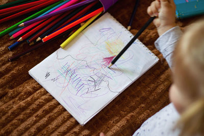 Midsection of woman drawing on paper