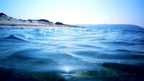 Scenic view of sea against clear blue sky