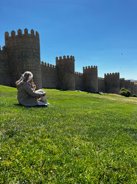 Scenic view of field against clear blue sky. muralla de Ávila.
