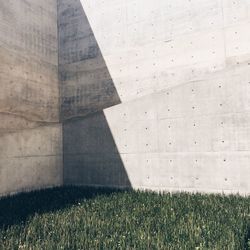 Shadow on structure by grassy field