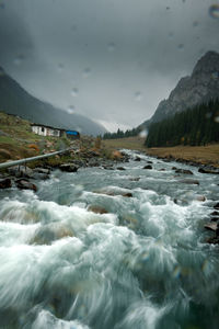 Scenic view of mountain river in rain