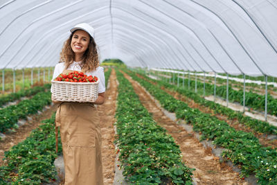 Portrait of a smiling young woman standing in farm